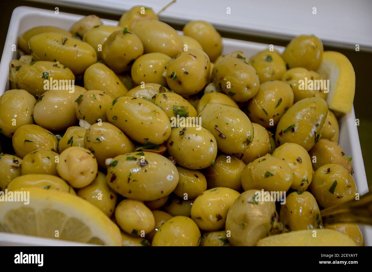 Green olives with coriander ready to eat. Vegetarian food Stock Photo