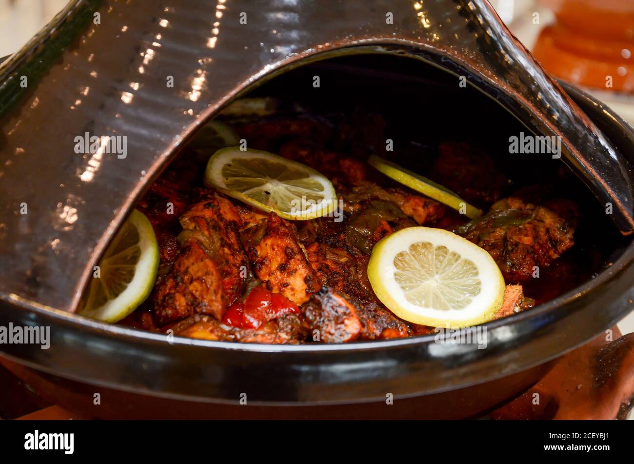 Moroccan fish tagine with chermoula, red peppers and preserved lemon close up Stock Photo
