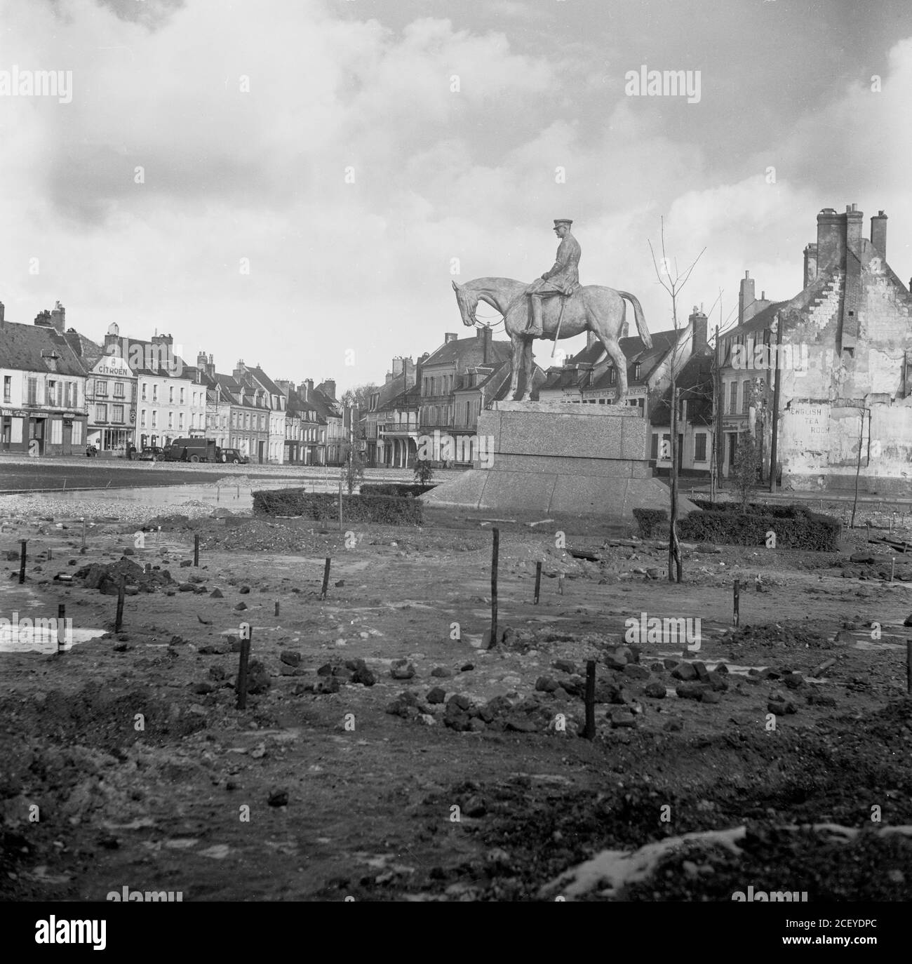 1950, historical, post-WW2 and a newly erected statue of a famous military figure sitting on a horse set amongst the earth, rubble and old buildings in the square of Montreuil-sur-Mer, France.The statue honours WW1 military hero Field Marshal General Haig commander of the British armed forces in France from 1915-1918. A controversial figure, his war strategy of attrition led to enormous numbers of casualties of British troops at both the Somme in 1916 and Third Battle of Ypress in 1917, but by weakening the German army, it can be argued that they helped ultimately in their defeat in 1918. Stock Photo