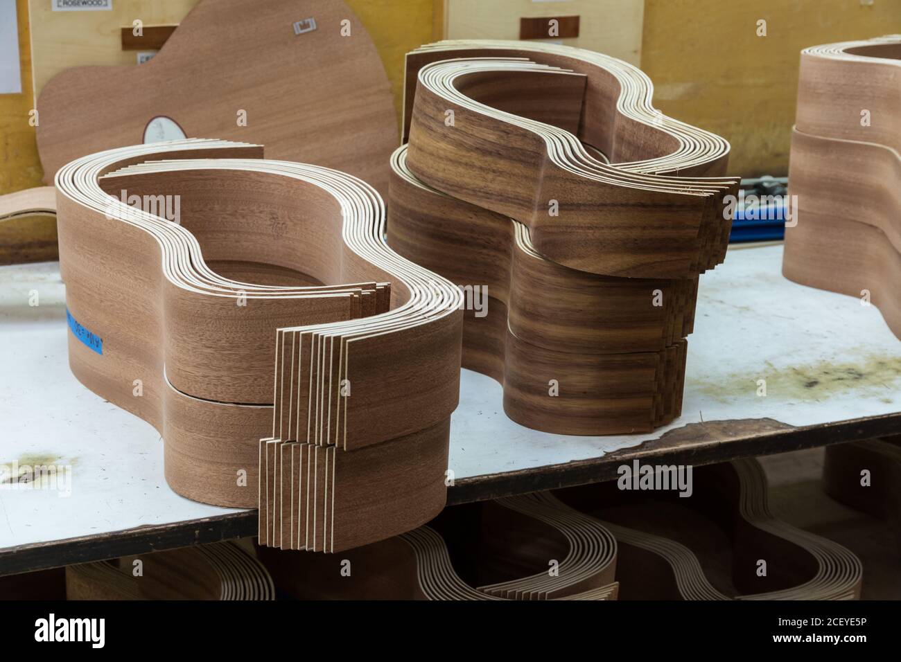 Curved exotic wood guitar sides are paired prior to gluing them together in the Taylor Guitar factory in Tecate, Mexico. Stock Photo