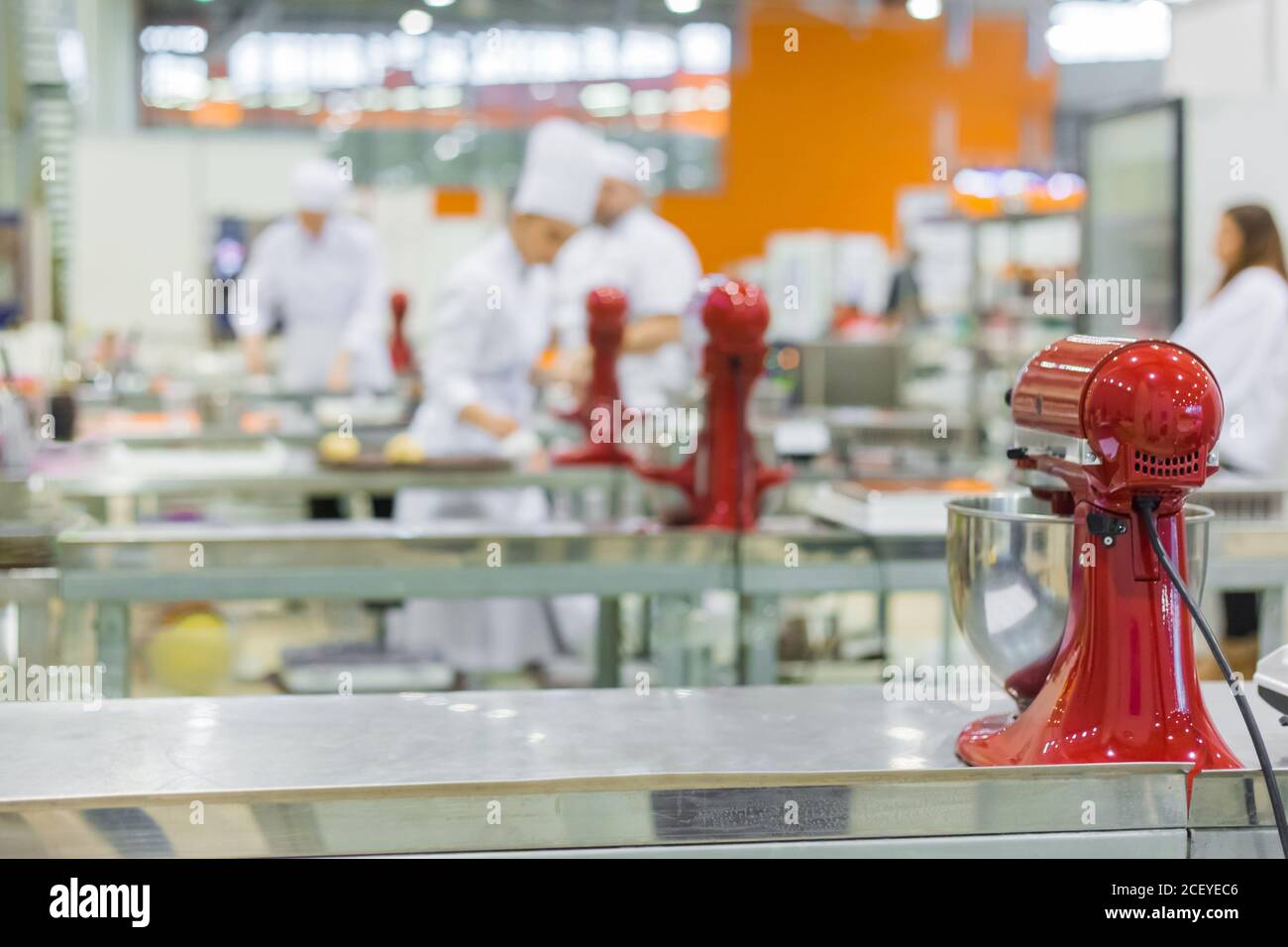 Professional chef, baker workplace with modern kitchen stand food mixers on tables at cuisine of