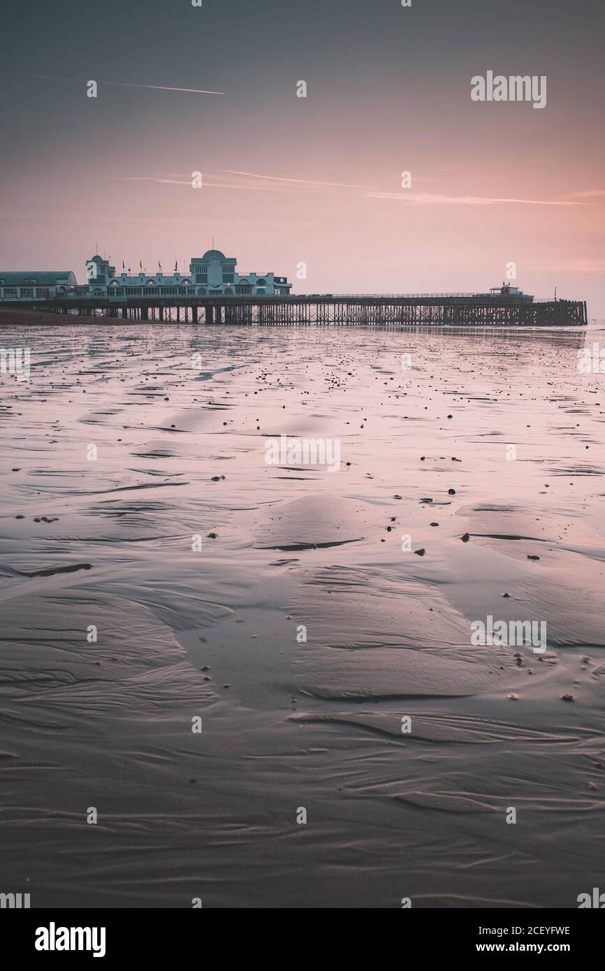 South Parade pier in Southsea at low tide during sunrise Stock Photo