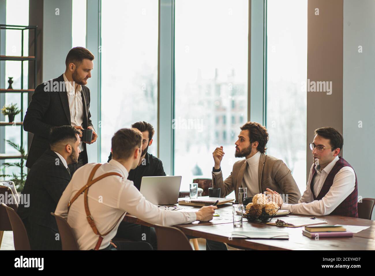 successful meeting of business crew consisted of young men leaders in formal wear, gathered to discuss business ideas and projects. isolated in modern Stock Photo