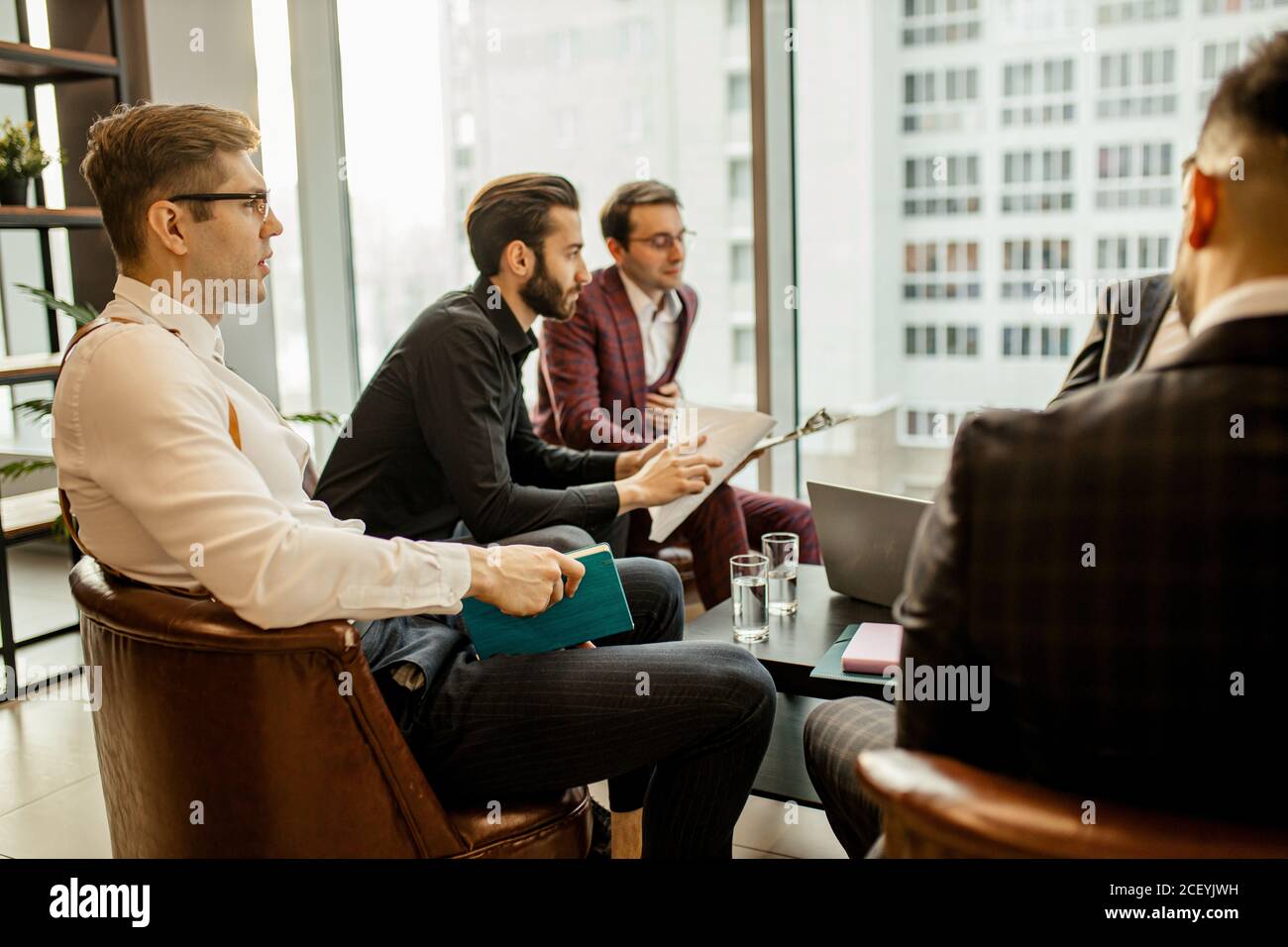 young caucasian successful business men hold meeting for making useful cooperation between companies, developing business strategies together in offic Stock Photo