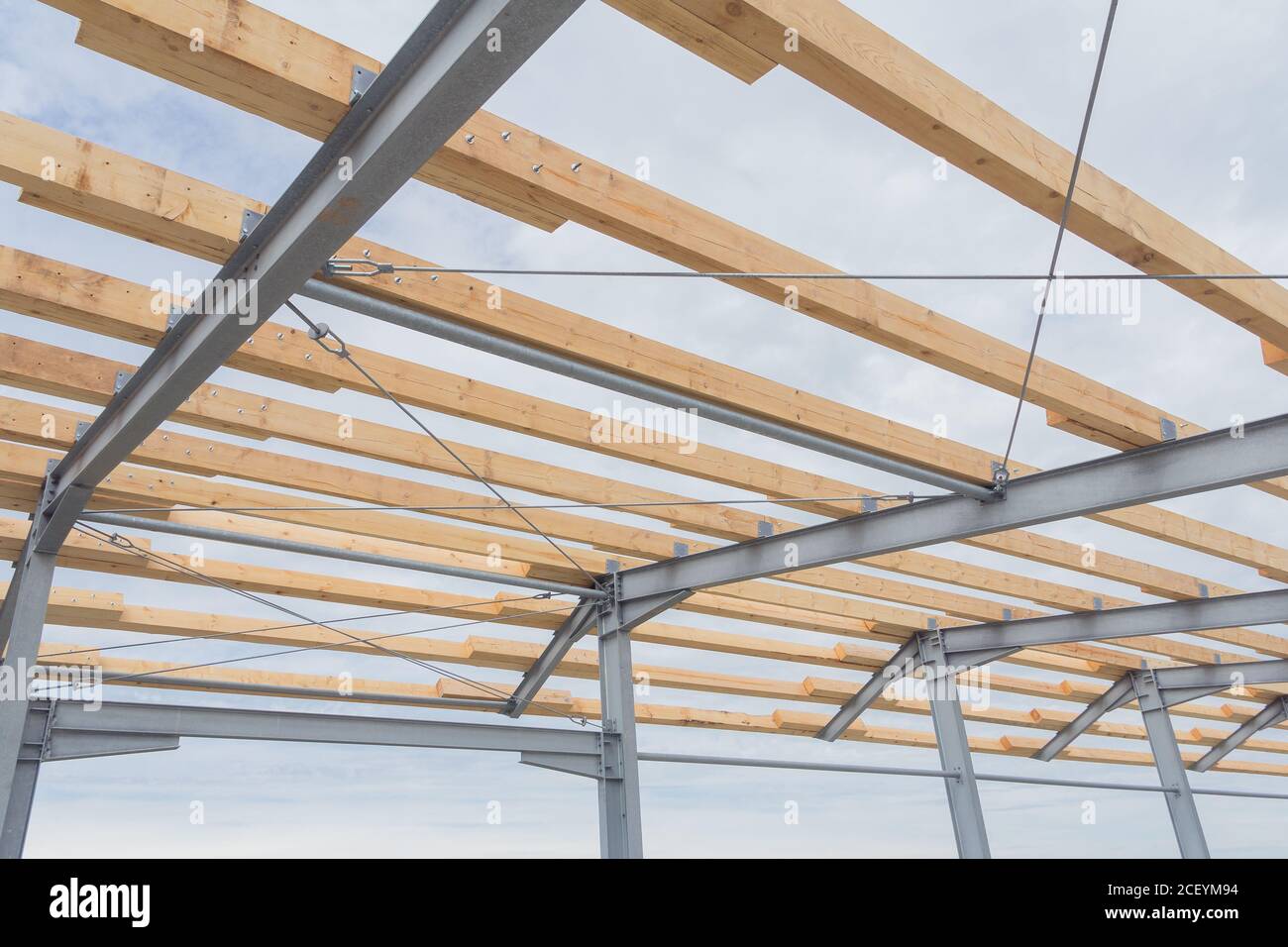 Roof construction from timber beams and steel frames. Agricultural