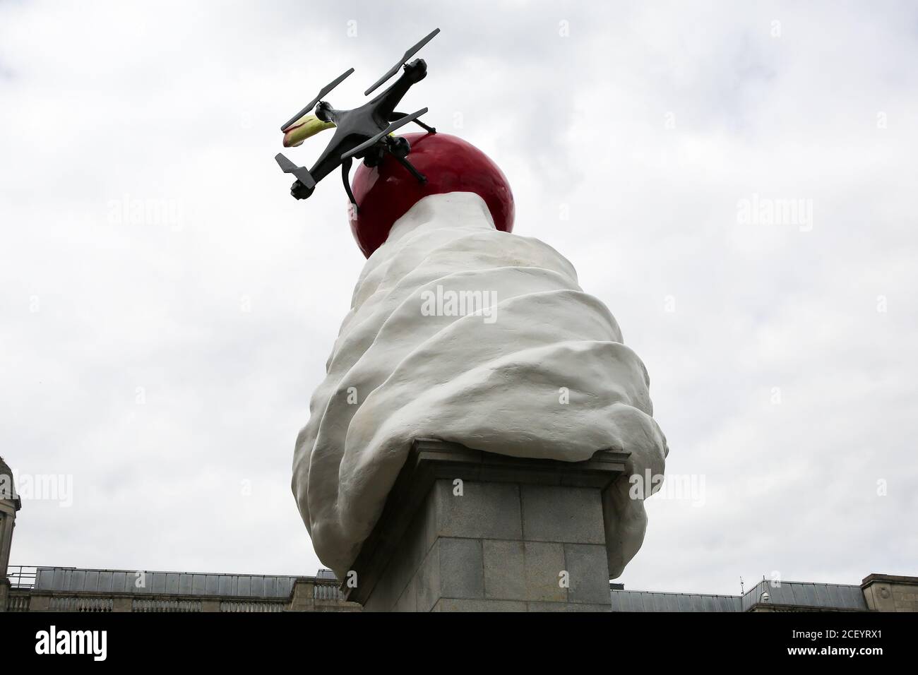 A view of a giant dollop of whipped cream topped with a cherry, a fly and a drone, a new artwork entitled 'THE END' by artist Heather Phillipson on the Fourth Plinth in London’s Trafalgar Square and will remain for the next two years. Stock Photo