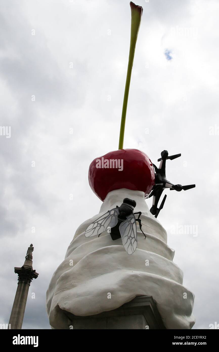 A view of a giant dollop of whipped cream topped with a cherry, a fly and a drone, a new artwork entitled 'THE END' by artist Heather Phillipson on the Fourth Plinth in London’s Trafalgar Square and will remain for the next two years. Stock Photo