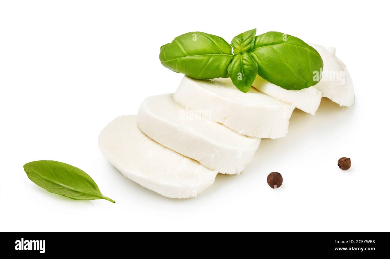 Pieces of mozzarella Buffalo cheese with basil leaves. Sliced cheese with black peppers isolated on white background. Stock Photo