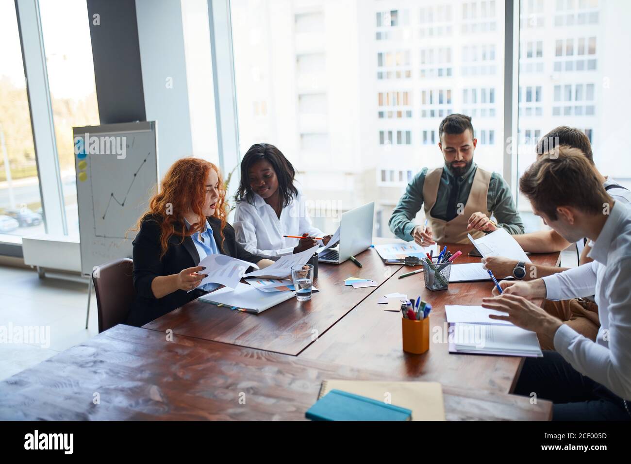 international group of people, business team gathered on table to discuss business ideas, using papers, diagrams. Creative business people Stock Photo