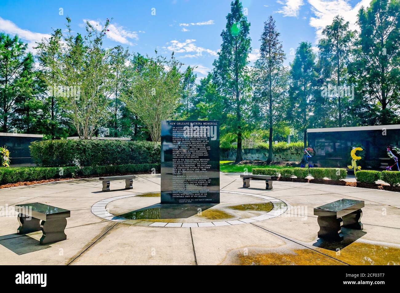 Flowers are placed in front of mausoleums for unknown hurricane victims at the Hurricane Katrina Memorial, Aug. 29, 2020, in New Orleans, Louisiana. Stock Photo