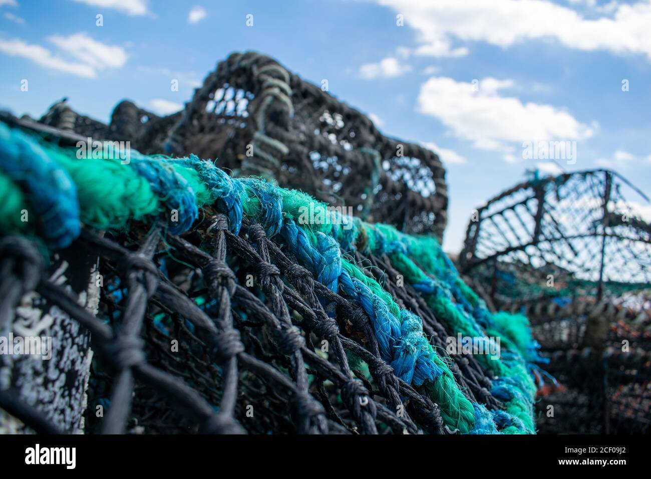 Crab trap cages in piles, clue rope closeup, dirty cages used to catch