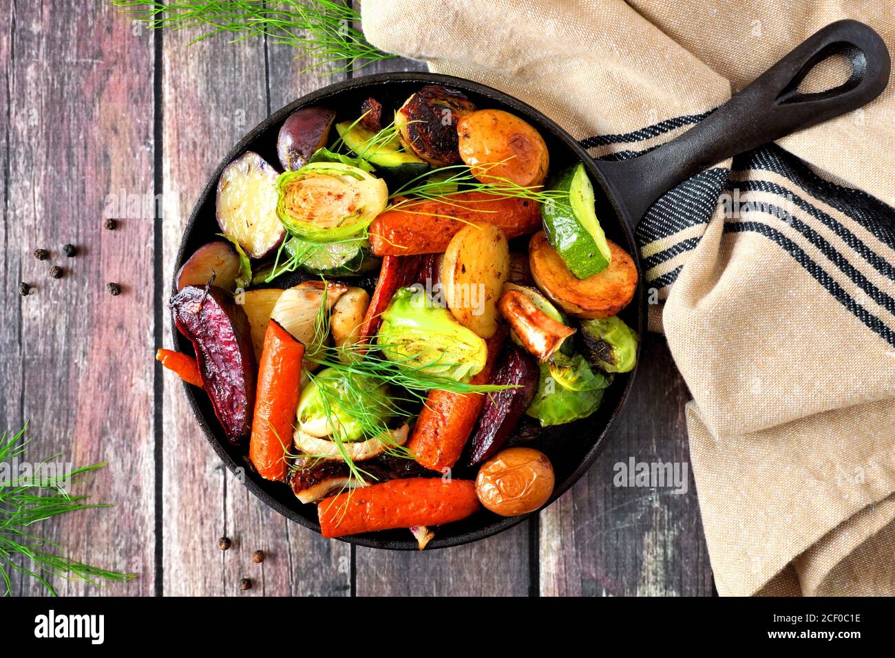Cast iron skillet of roasted autumn vegetables, overhead scene on a