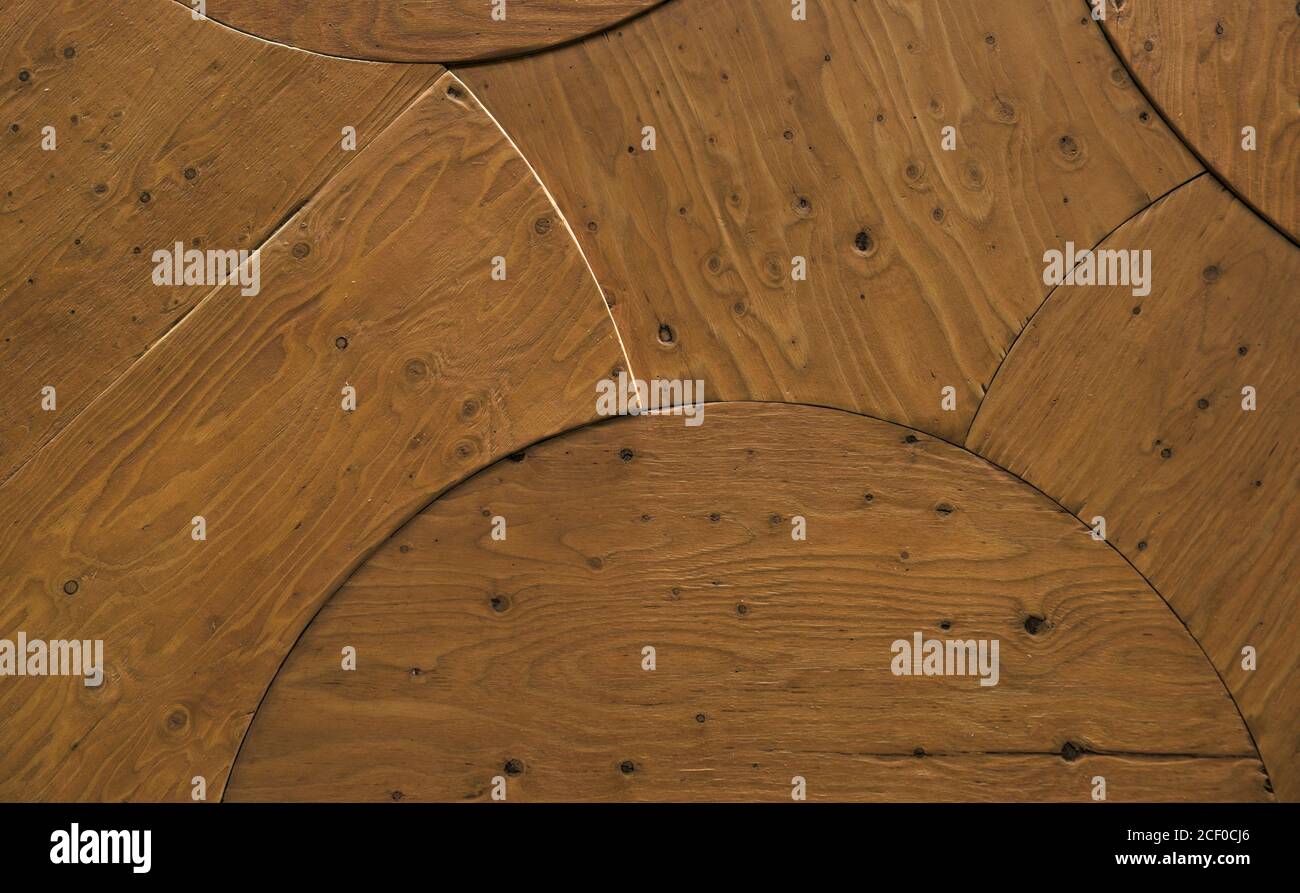 Textured surface of wooden boards cut and fit together in a curved