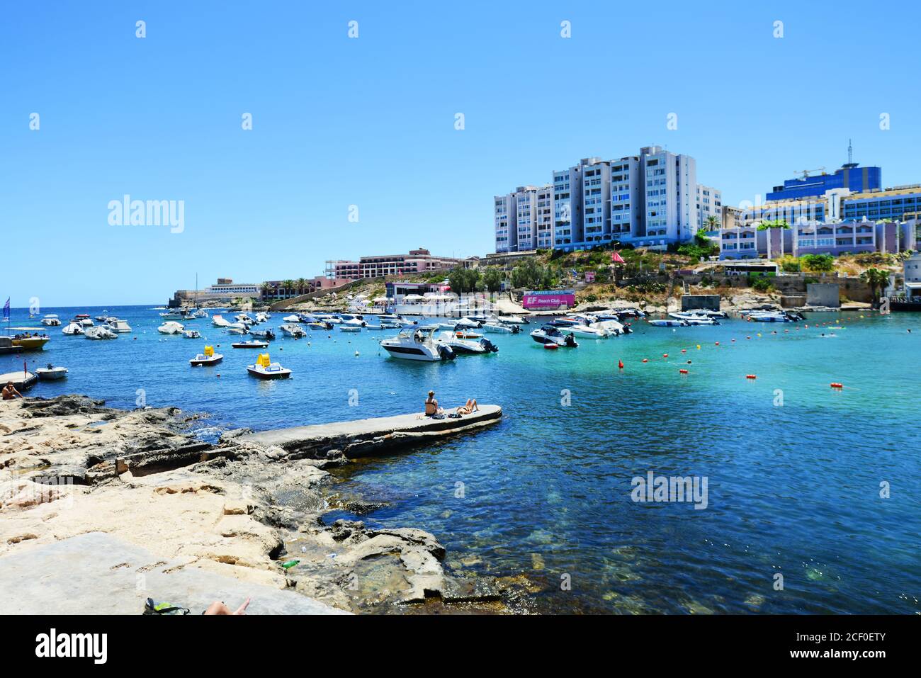 The Vibrant Beach Of St George s Bay In St Julian s Malta Stock Photo the-vibrant-beach-of-st-george-s-bay-in-st-julian-s-malta-stock-photo