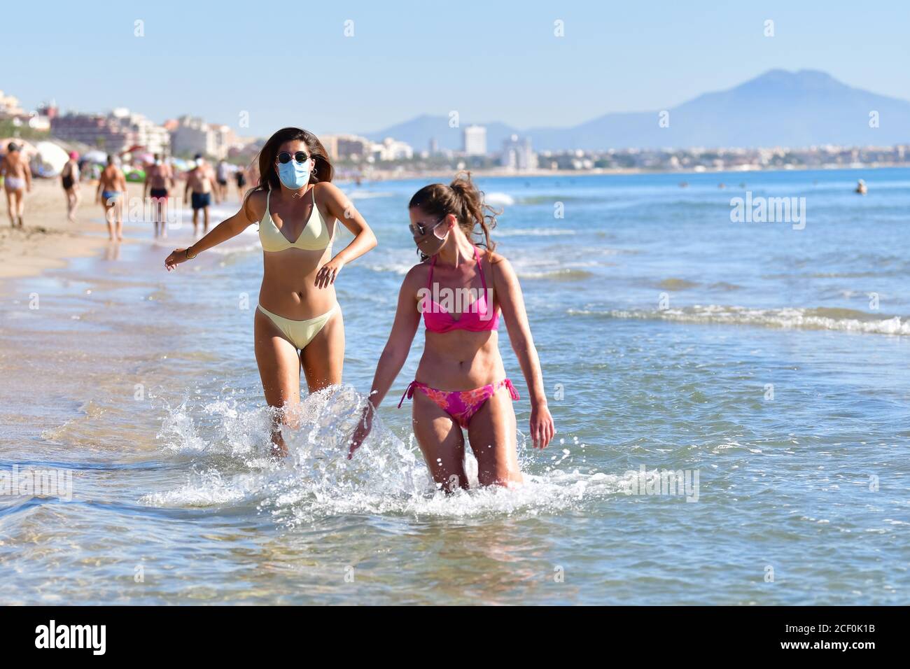 Two Young Girls On The Beach In The Summer Wearing Bikinis Stock Photo,  Picture and Royalty Free Image. Image 18356677.