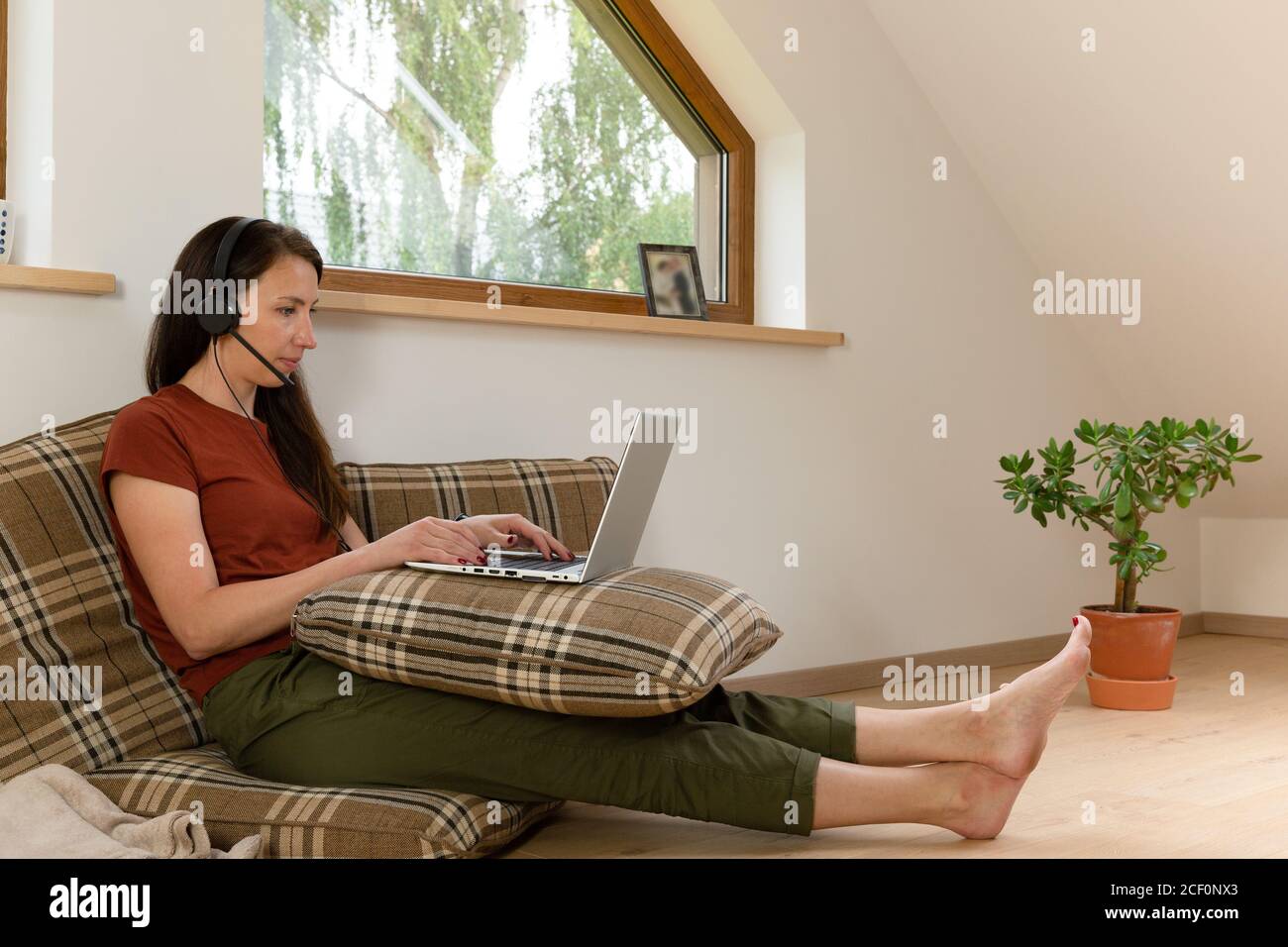 Women working from home on a conference call. Desk made from pillows. New normal concept Stock Photo