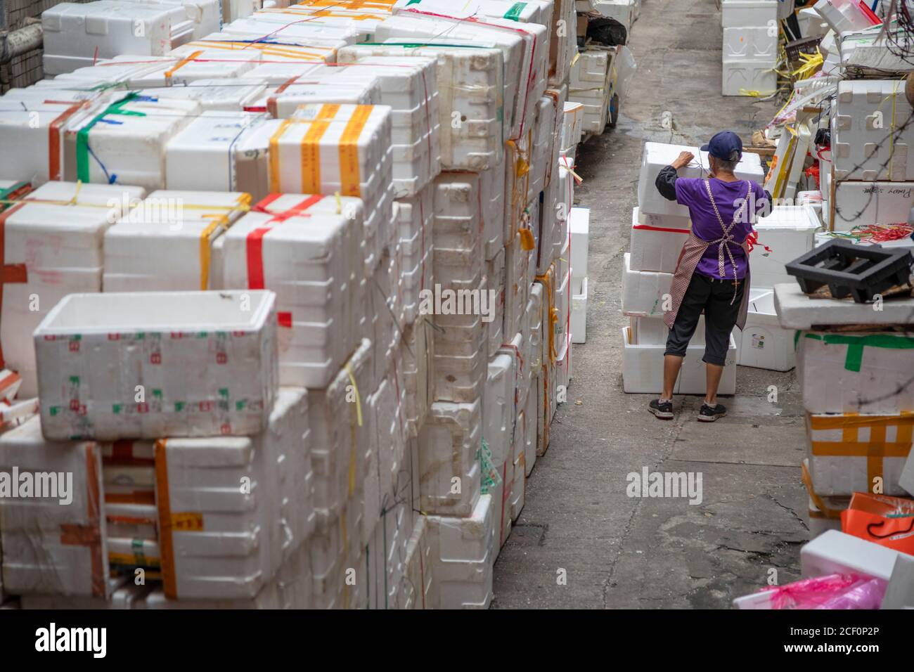 Woman collecting boxes, Sai Ying Pun, Hong Kong Island, Hong Kong Stock Photo
