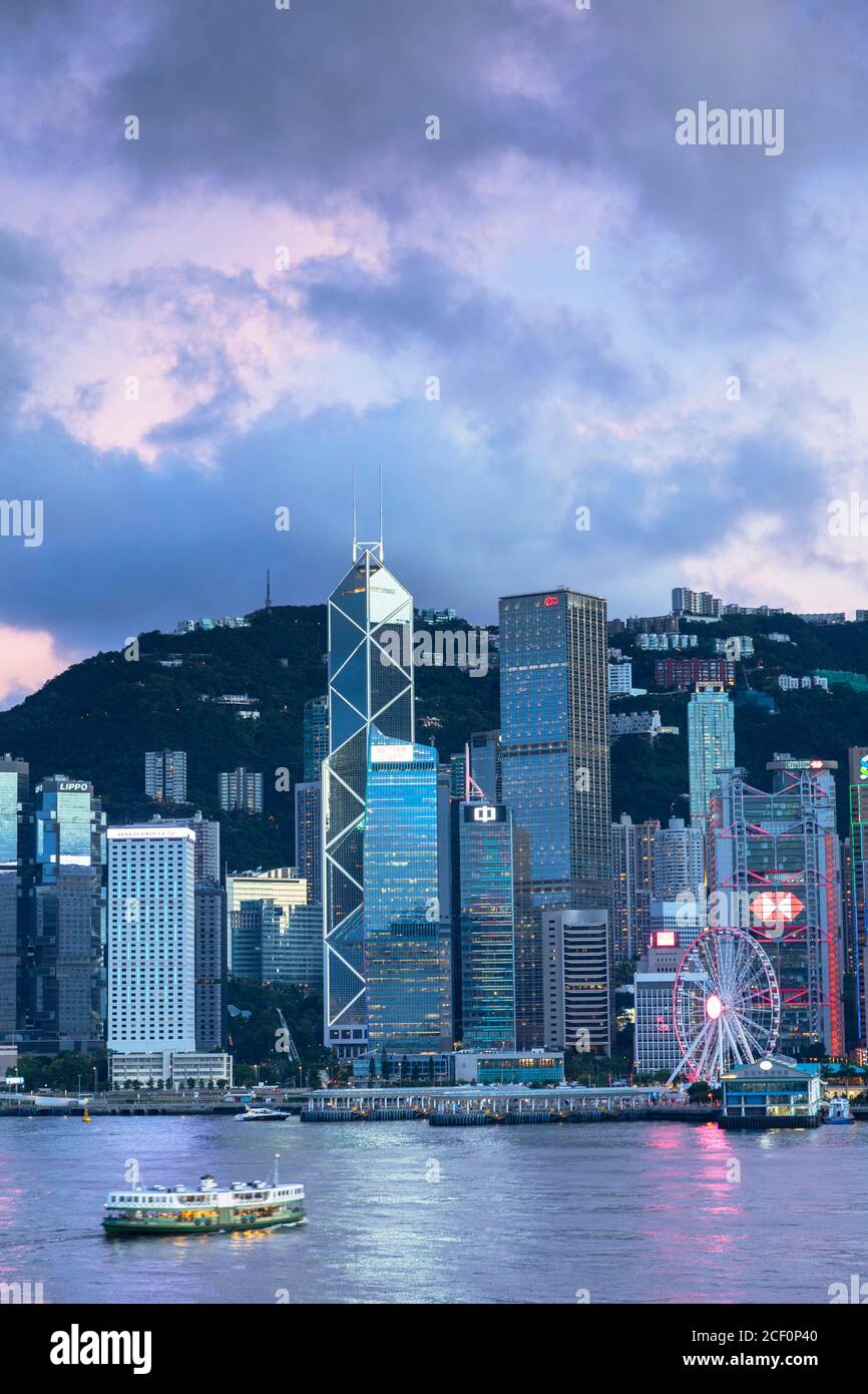 Skyline of Hong Kong Island and Star Ferry at sunset, Hong Kong Stock Photo