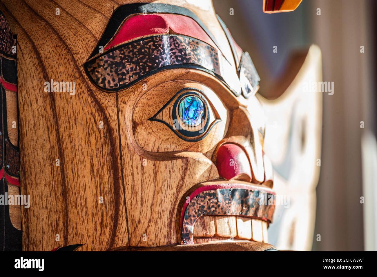 Totem sculpture art on wood pole in Alaska. Stock Photo