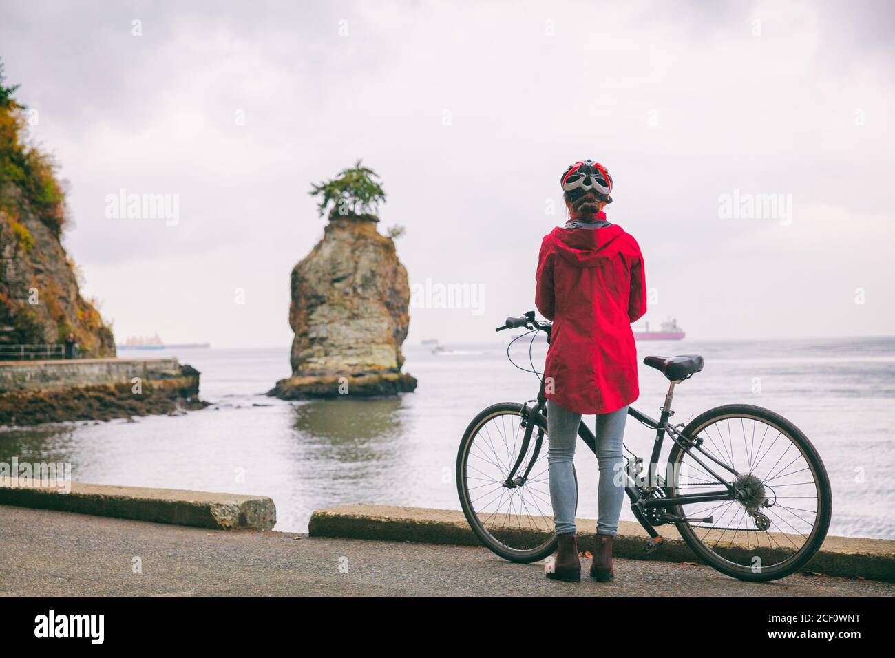 Vancouver city bike woman tourist cyclist biking in Stanley Park, tourist attraction in British Columbia, Canada. Canadian lifestyle commute. Stock Photo
