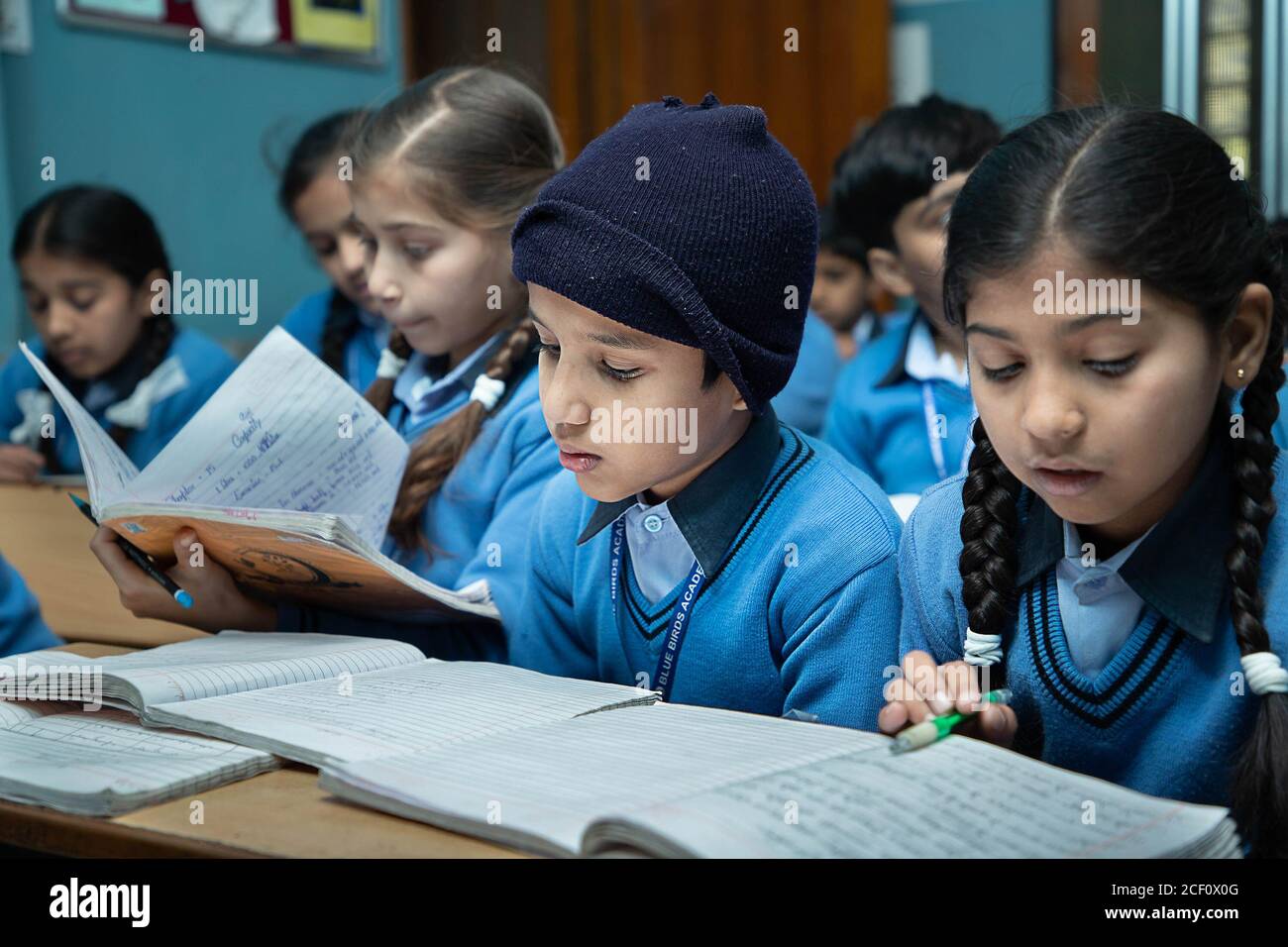 Jodhpur, Rajasthan, India - Jan 10th 2020: Primary indian students studying in the Classroom Taking Exam / Test Writing in Notebooks. education concep Stock Photo