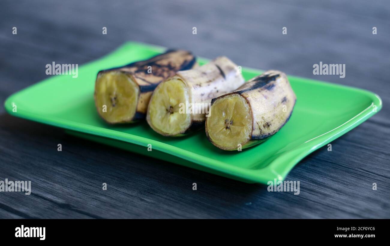 Boiled banana on wood background. Stock Photo