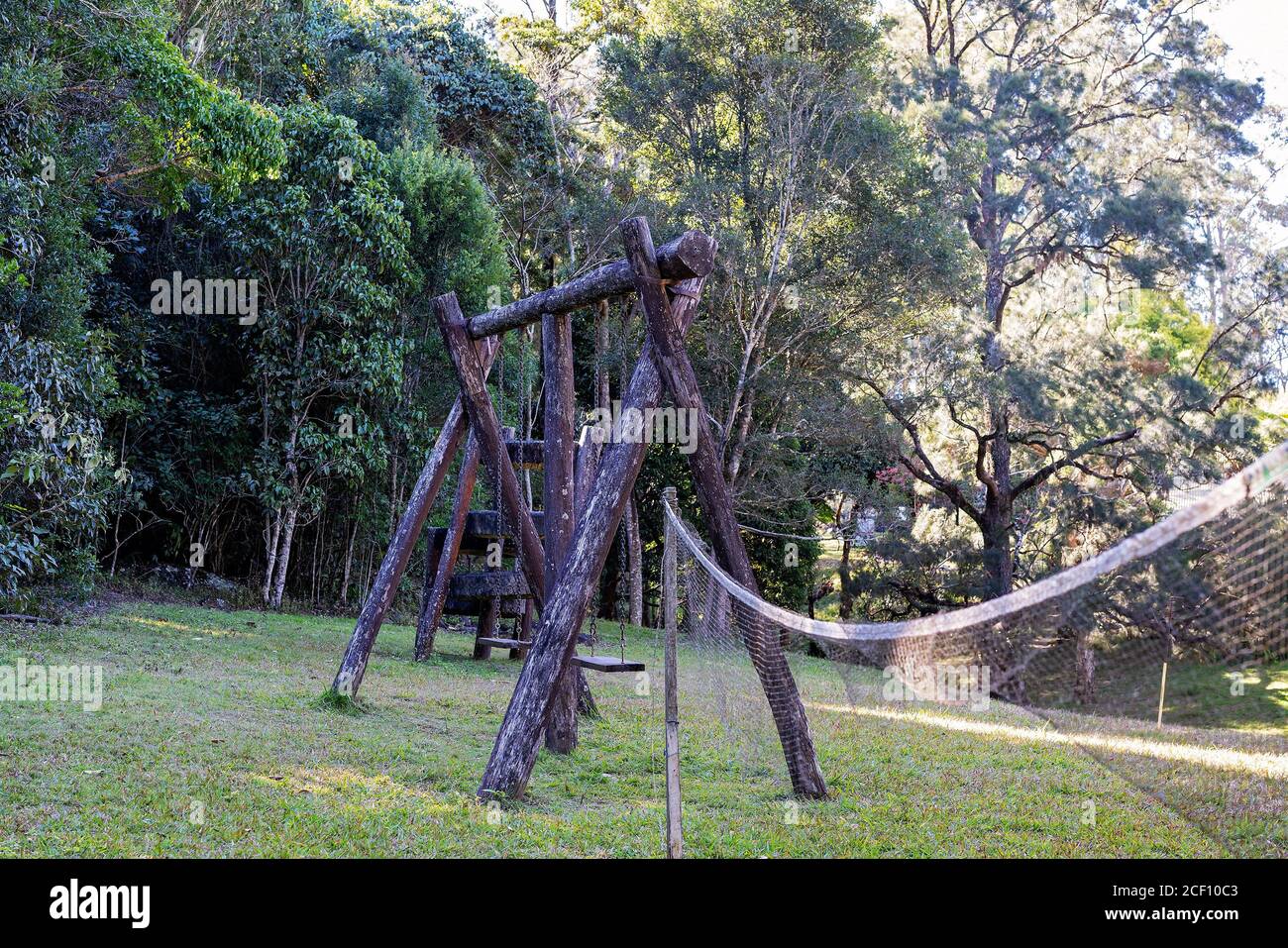 An old moldy swing set, climbing frame and dilapidated net in a