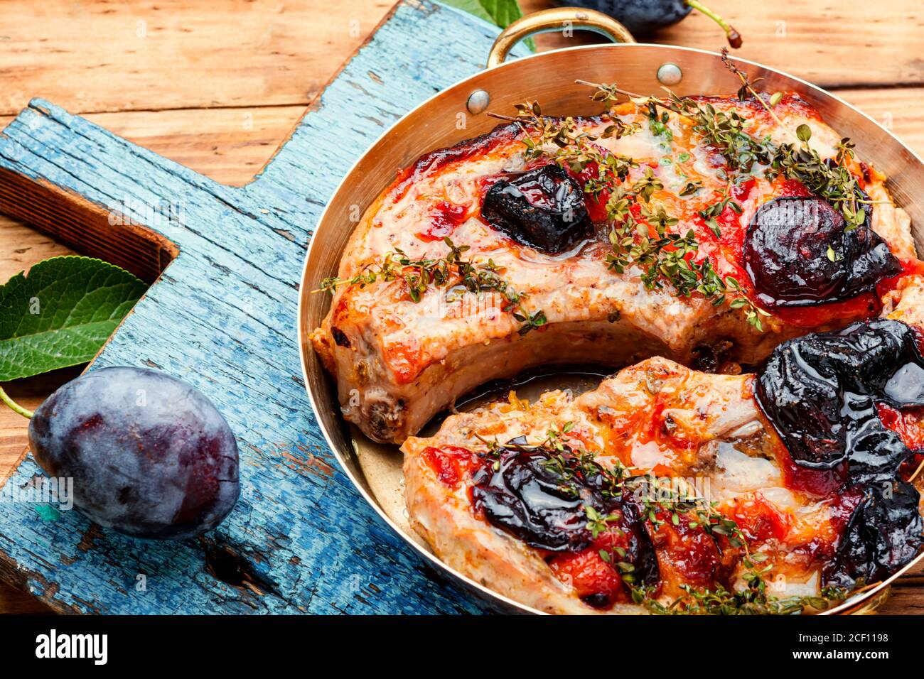 Appetizing pork steak cooked in plum sauce Stock Photo