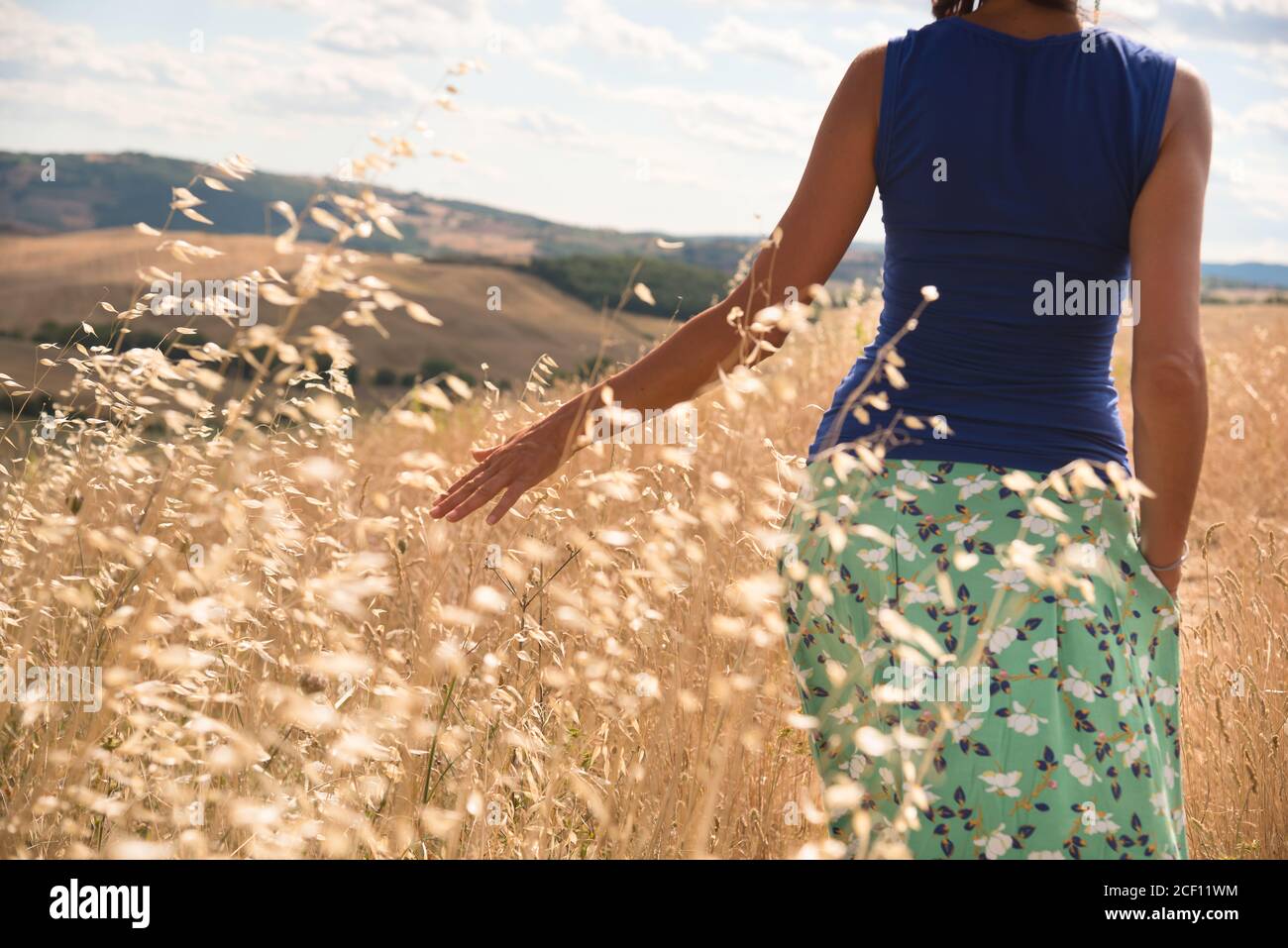 Young girl walking in open field Stock Photo - Alamy