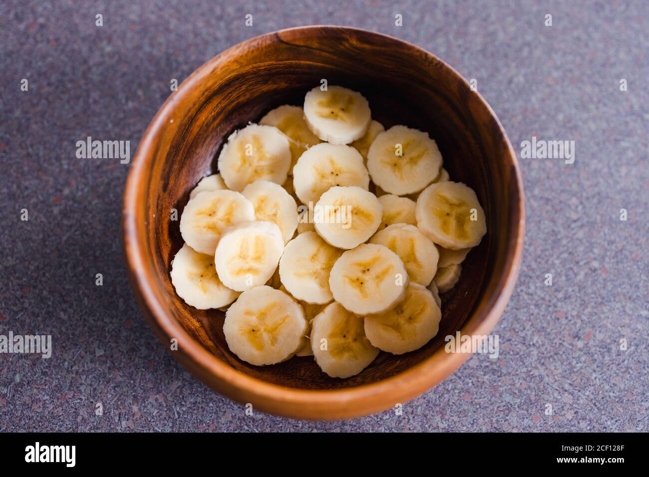 Simple Food Ingredients Concept Sliced Banana In Wooden Bowl As