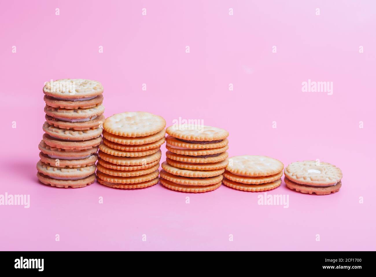 Cream sandwich biscuits on pink background Stock Photo