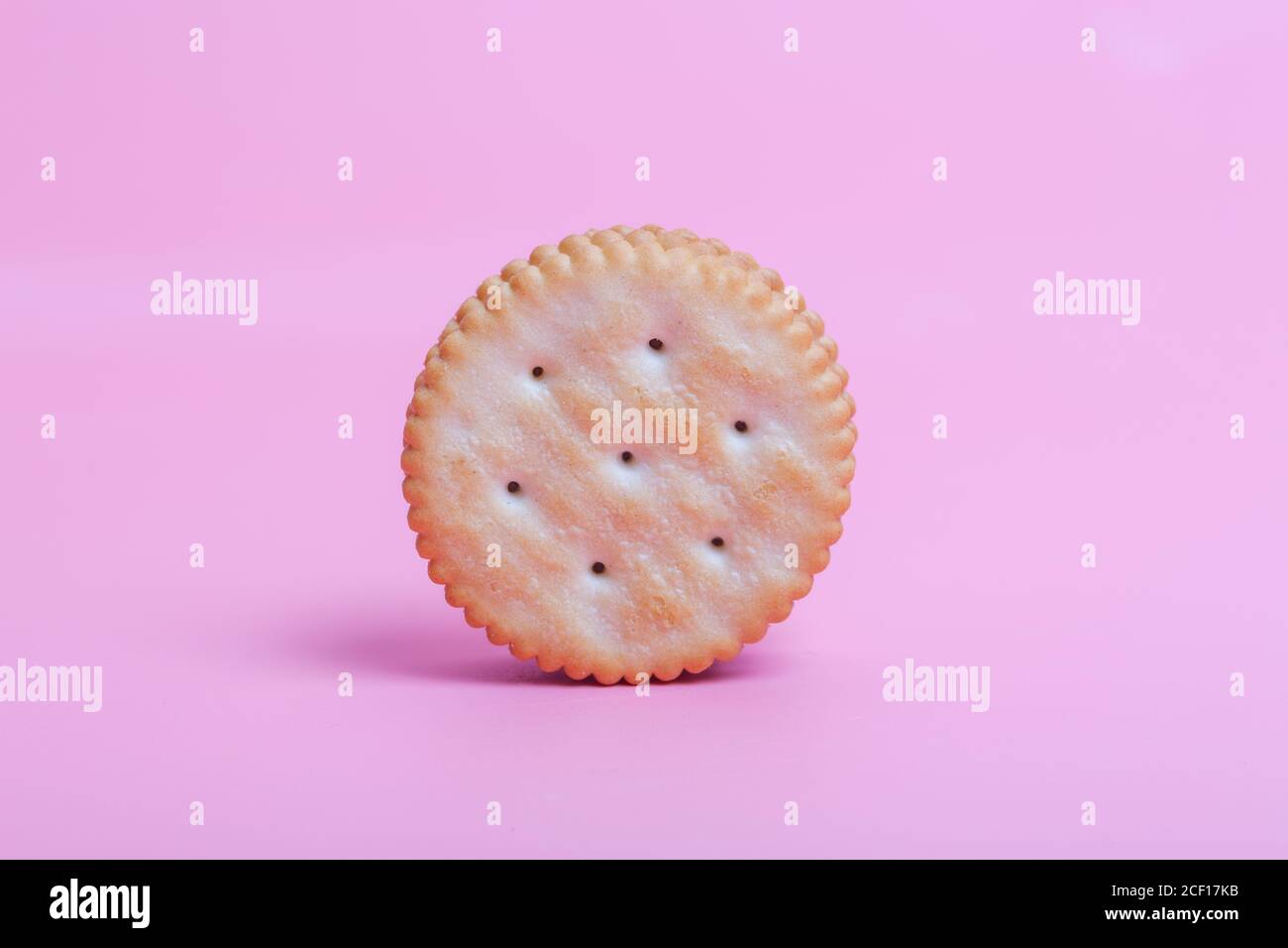 Cream sandwich biscuits on pink background Stock Photo