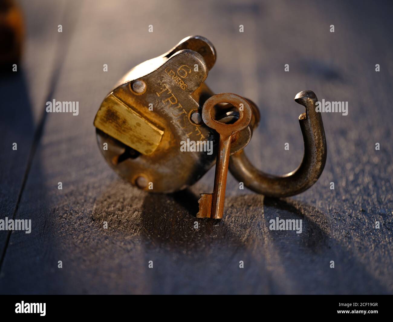 Trusty Padlock with key on weatehered textured wooden table top Stock ...