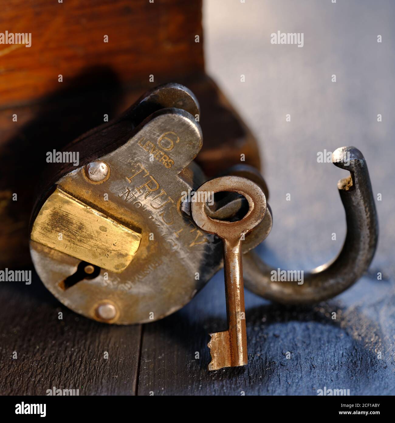 Trusty Padlock with key on weatehered textured wooden table top Stock ...
