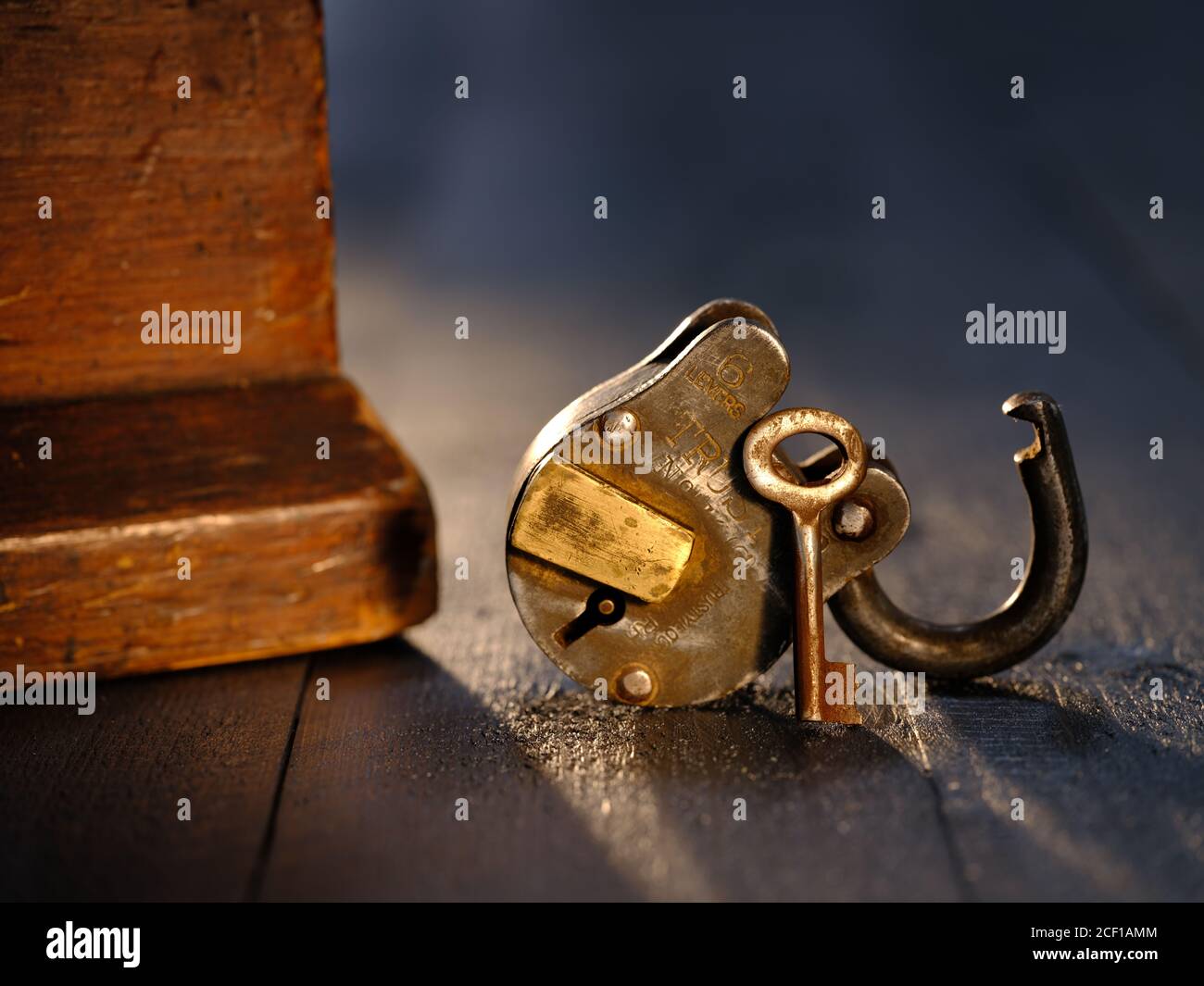 Trusty Padlock with key on weatehered textured wooden table top Stock ...