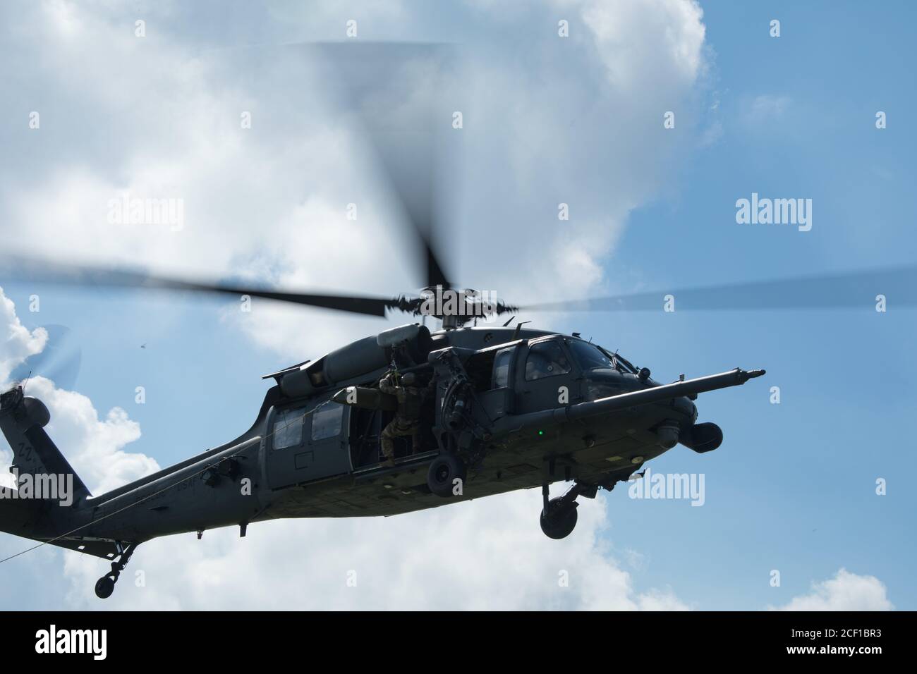 TORII STATION, Japan –A U.S. Air Force HH-60 Pave Hawk helicopter transports a simulated casualty during medical evacuation training Aug. 19, 2020, at Torii Station, Okinawa Prefecture, Japan. Special Forces Soldiers often conduct MEDEVAC training to ensure they are prepared to swiftly transport wounded to follow-on medical facilities in case of real-life scenarios that may occur during operations. (U.S. Army photo by Sgt. Anthony Bryant) Stock Photo