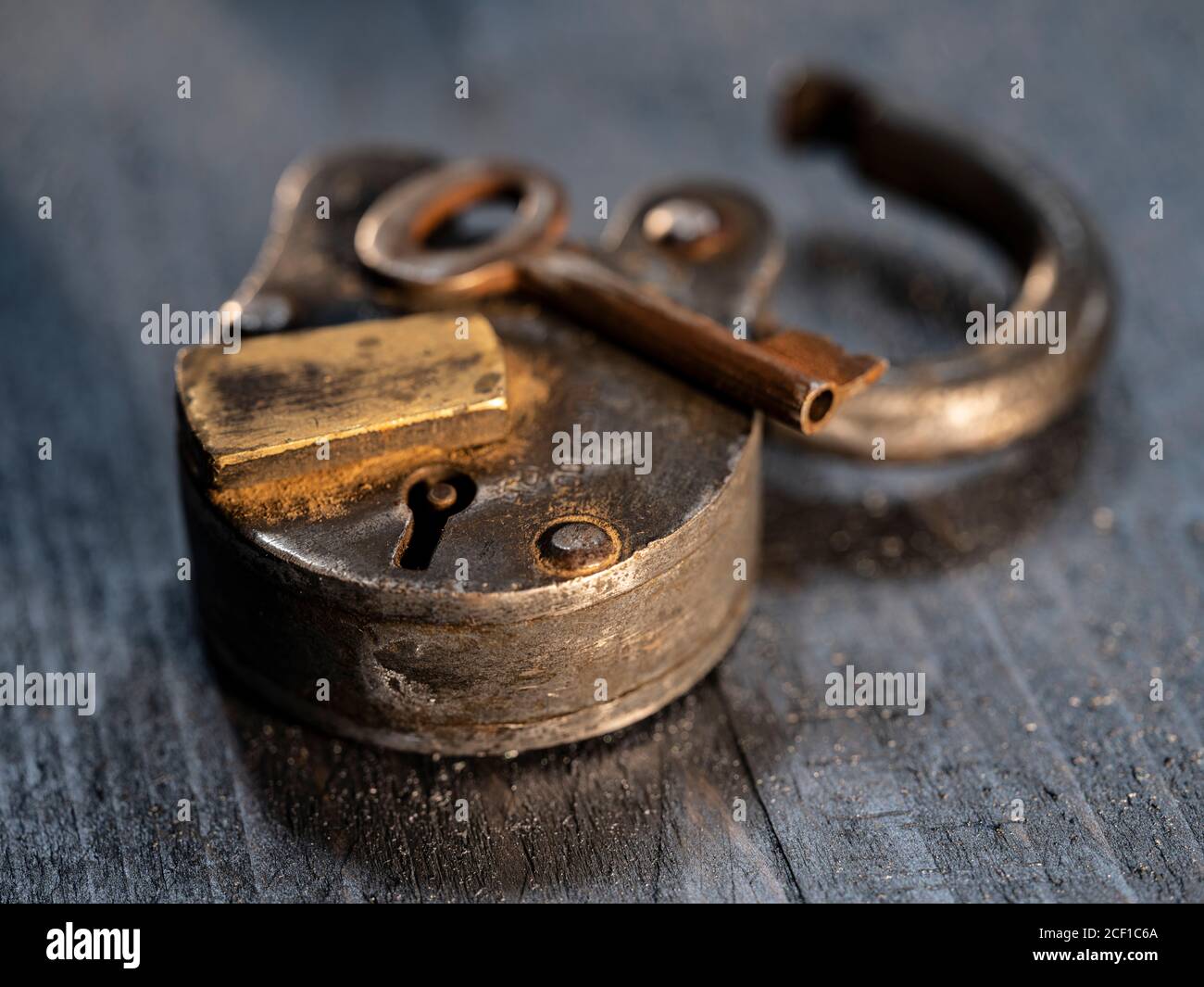 Trusty Padlock with key on weatehered textured wooden table top Stock ...