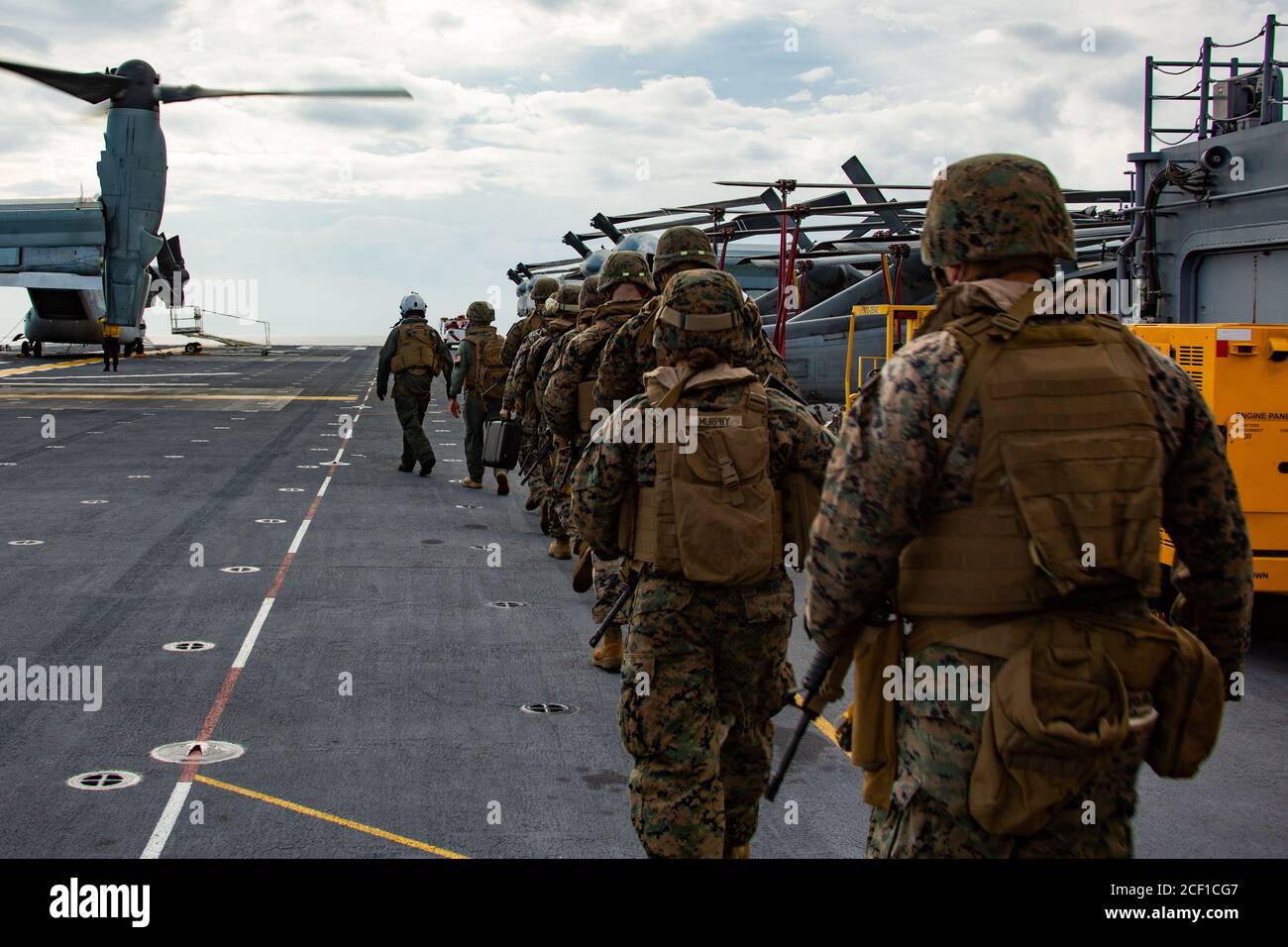 PHILIPPINE SEA (Sep. 2, 2020) Marines with the Forward Command Element (FCE), 31st Marine Expeditionary Unit (MEU), board a MV-22B Osprey with Marine Medium Tiltrotor Squadron 262 (Reinforced), for an embassy reinforcement drill, aboard amphibious assault ship USS America (LHA 6). The FCE is prepared to deploy to U.S. embassies in the region in order to establish communication and coordination with the MEU for follow on missions. The America, flagship of the America Amphibious Ready Group, 31st MEU team, is operating in the U.S. 7th Fleet area of operations to enhance interoperability with all Stock Photo
