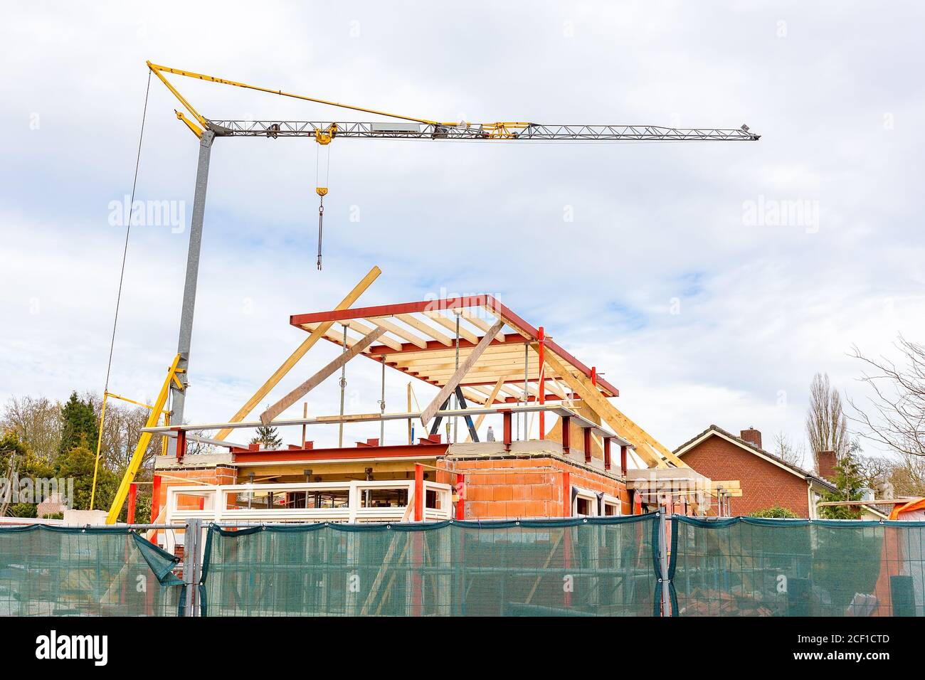 Building site with crane and house under construction Stock Photo