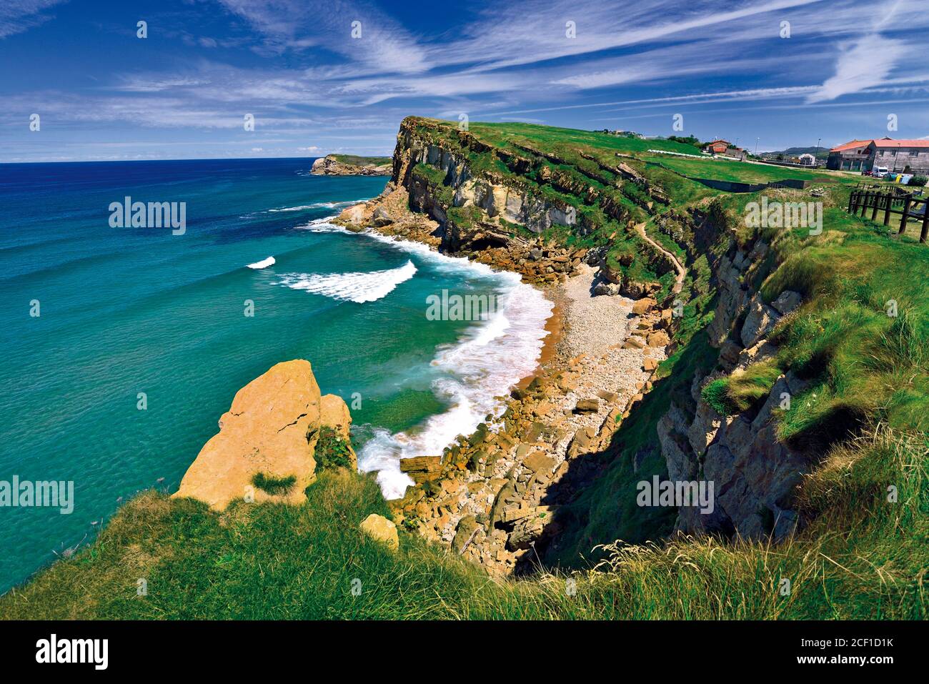 Wild beautiful cliffs and coastal view with green ocean and blue sunny sky Stock Photo