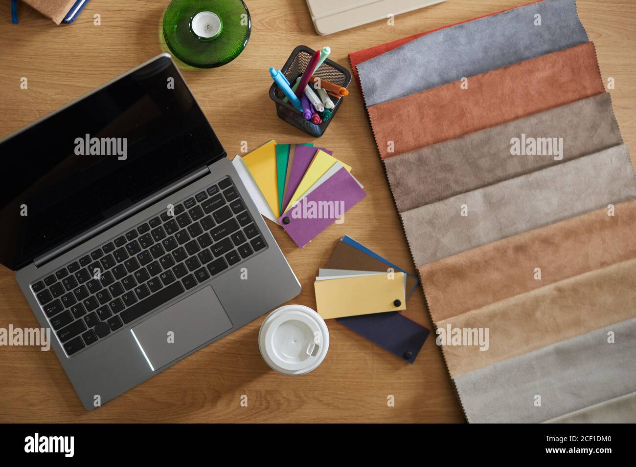 High angle view of workplace of designer with laptop and fabric samples Stock Photo