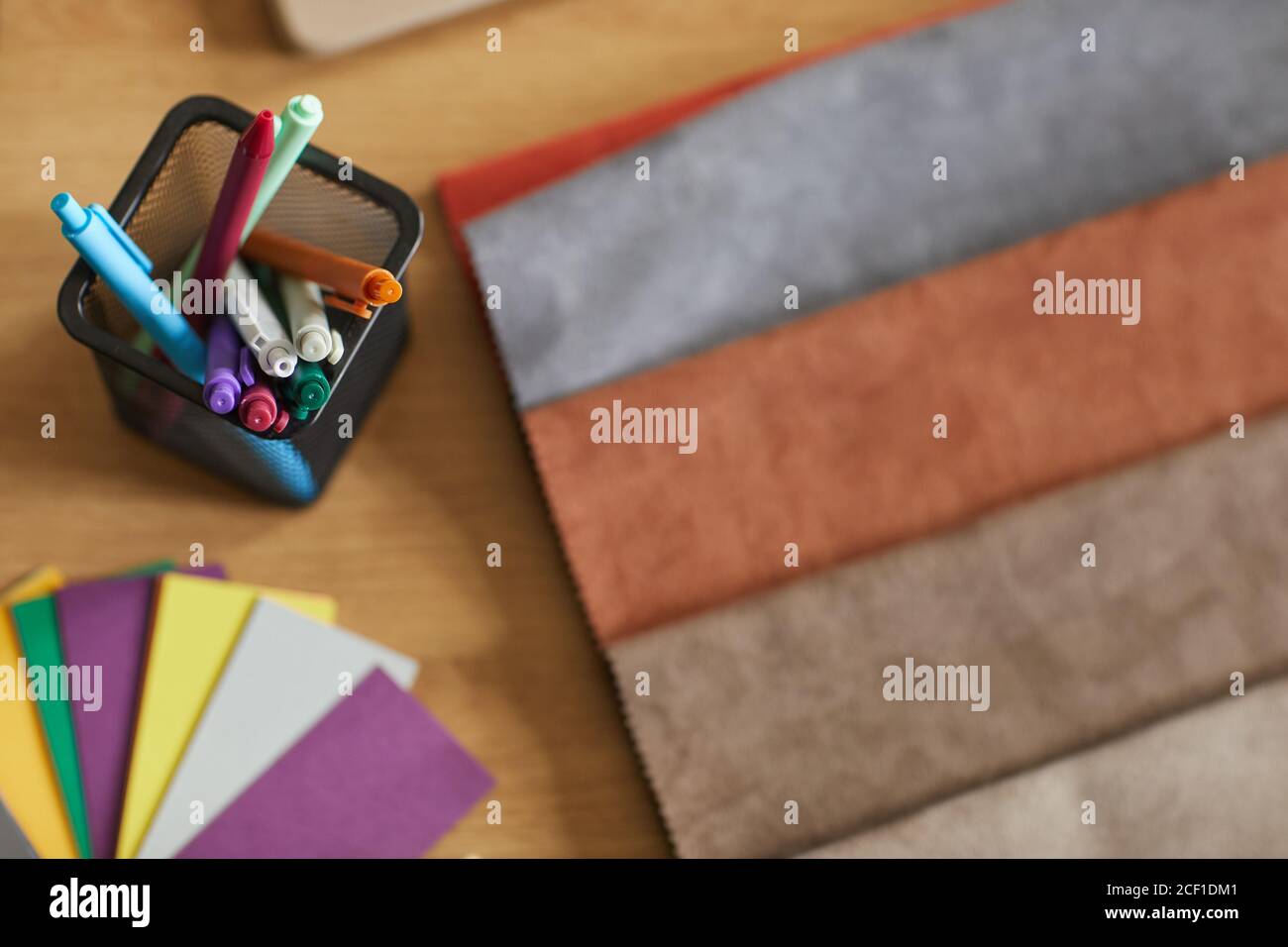 Close-up of colored markers and fabric samples on the workplace of designer Stock Photo