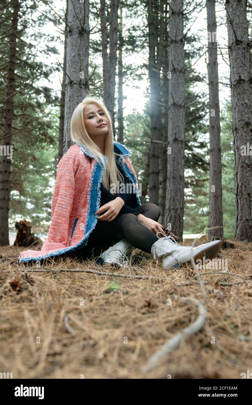 Beautiful asian woman relaxing in the middle of a pine forest. Stock Photo
