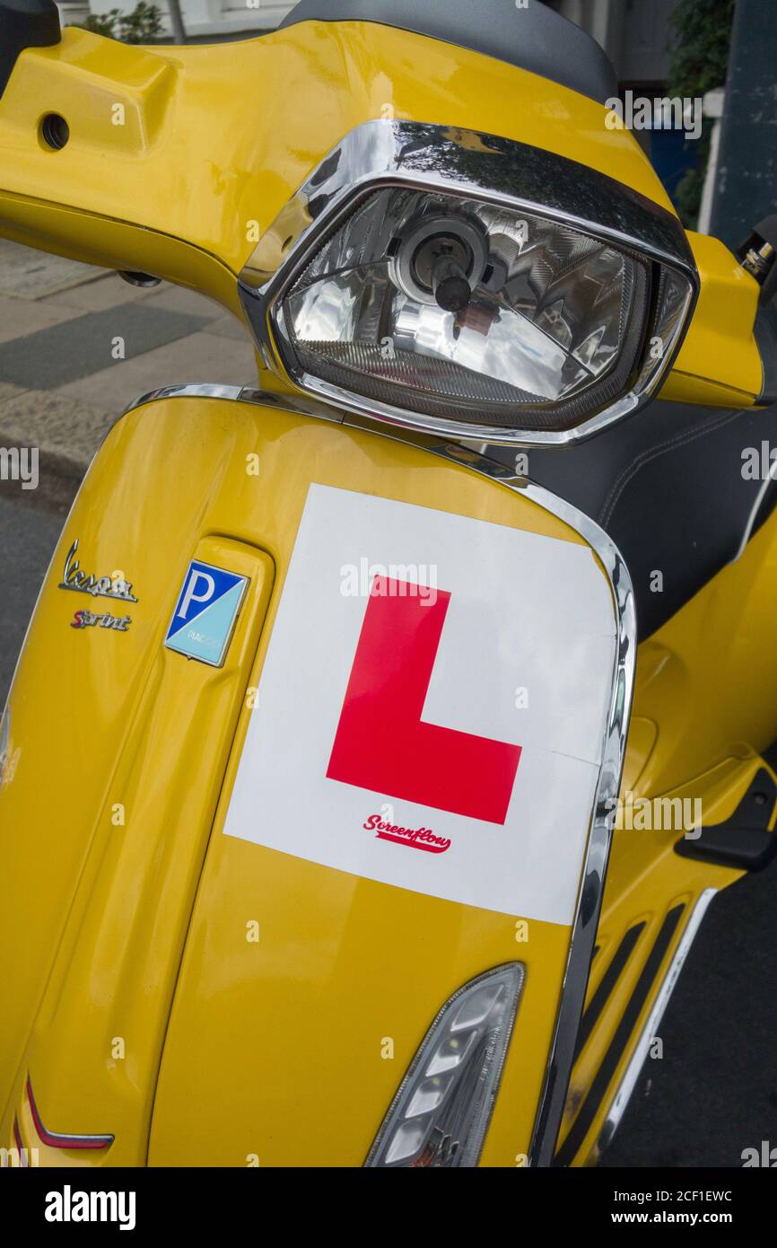 L Plates on an iconic, yellow, Vespa Piaggio Sprint Stock Photo