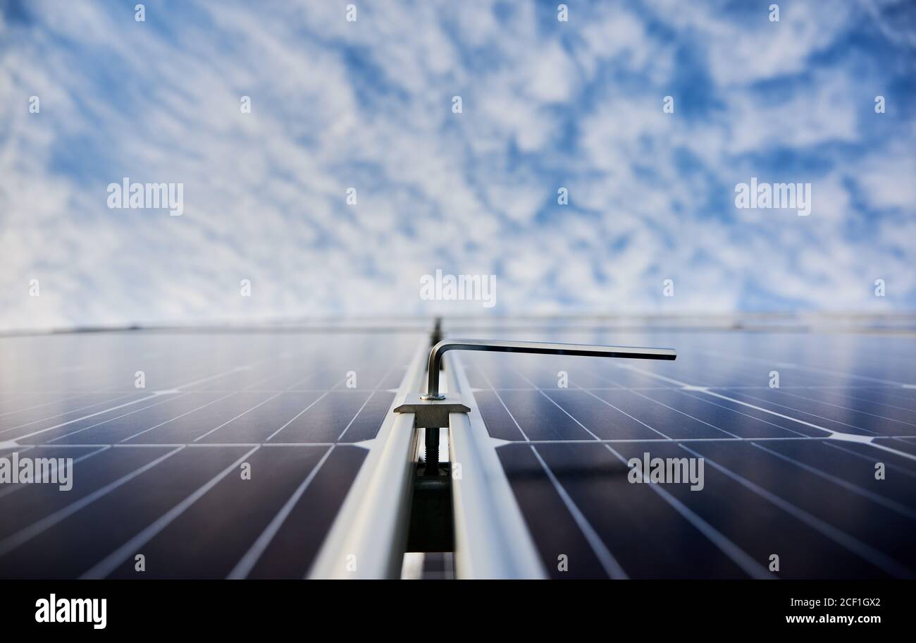 New solar module with beautiful blue sky on blurred background. Solar power system for generating electricity through the photovoltaic effect. Concept of alternative energy, ecological solution Stock Photo