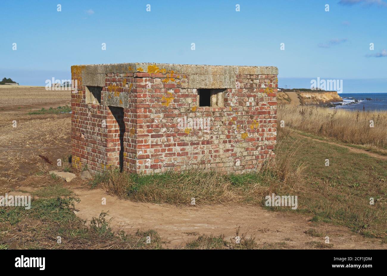 A World War Two Type 26 Square Pill Box standing by the cliff top on