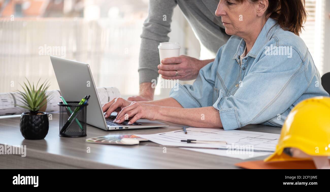 Architects working on new construction project and using laptop Stock Photo