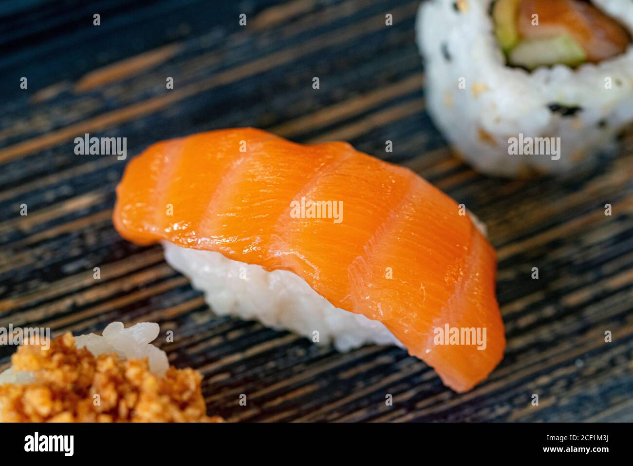 a isolated smoked salmon nigiri sushi among varied sushi pieces Stock Photo