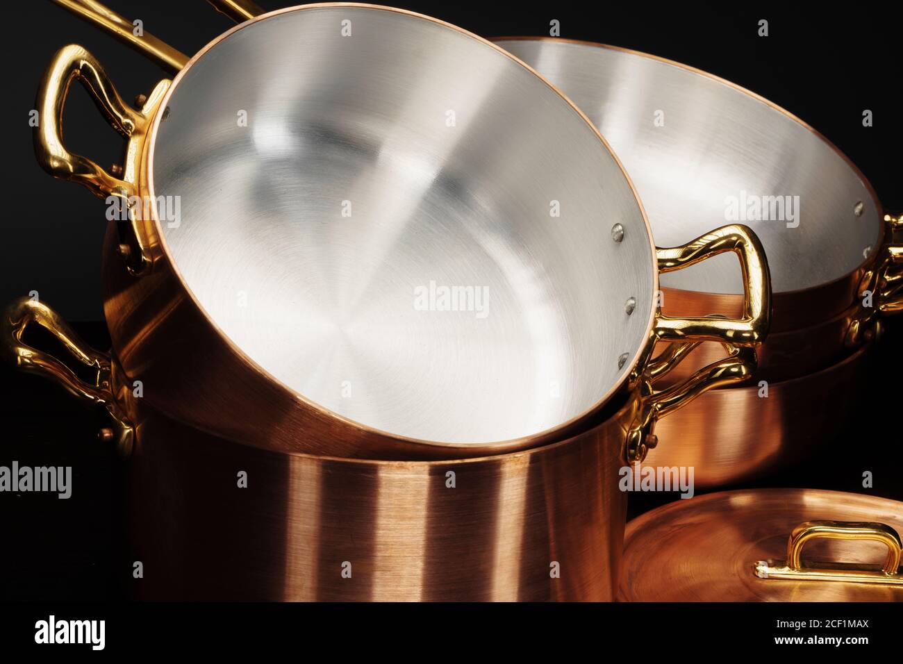 Set of copper cookware over dark background Stock Photo Alamy