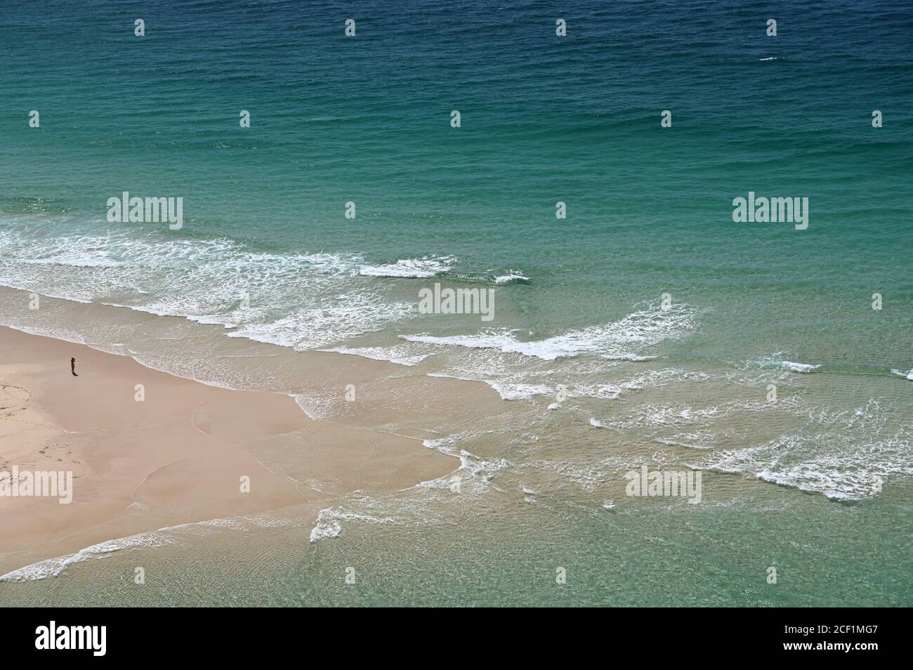 Beach sand sea water summer background. Sand beach desert texture. White  foam wave sandy seashore top view Stock Photo